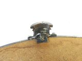 a close up of a metal object on a wooden surface