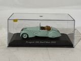 a small toy car in a clear case on a table