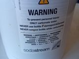 a white bucket with a warning label on it