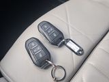 two car keys sitting on the back of the seat of a car
