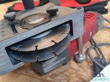 someone is using a circular saw to cut a hole in a piece of wood