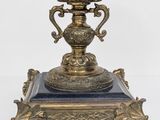 a blue vase sitting on top of a gold stand