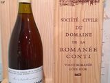 a bottle of wine sitting next to a wooden box