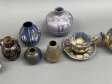 many different types of vases sitting on a table