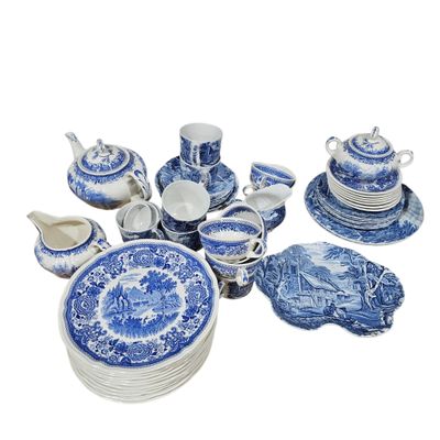 blue and white porcelain dishes and cups and saucers on a white background