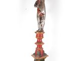 a statue that is on top of a red pedestal