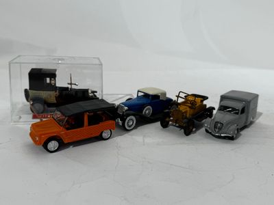 several toy cars are lined up in a row on a white surface