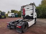 a truck that is parked in a lot with other trucks