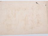an old piece of paper sitting on top of a white table