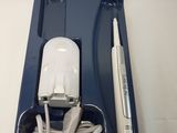 a toothbrush, toothpaste, and charger in a blue tray