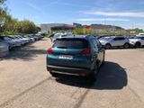 many cars parked in a parking lot near a building