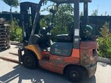 an image of a forklift truck parked in a lot
