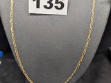 un gros plan d'un collier porté par un mannequin, avec une étiquette de prix
