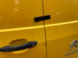 a close up of a yellow car with a black door handle