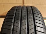 a close up of a tire on a box with a cardboard box in the background