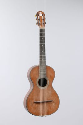 an image of a guitar hanging from a string on a white wall