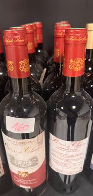 bottles of wine are lined up on a shelf in a store