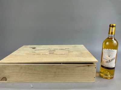 a wooden box with a bottle of wine next to it