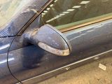 a close up of a car ' s side mirror and door handle