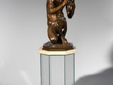 statue of a man holding a baseball bat on a pedestal