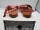 a pair of women ' s sandals in a box on a white surface