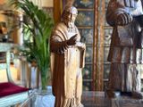 a statue of a man and a statue of a woman in a living room