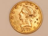 a close up of a gold coin with a woman ' s head on it