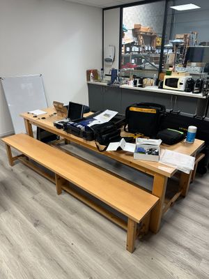 a wooden table with a laptop on it in a room