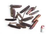 many different types of pocket knives on a white surface