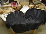 a table with a lot of clothing on it in a room