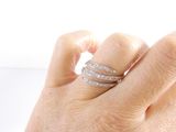 a woman ' s hand with a diamond ring on it ' s finger