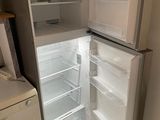 an open refrigerator in a small kitchen with the door open