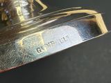 a close up picture of a silver bell on a table
