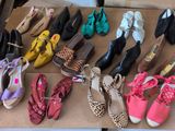 many pairs of shoes that are sitting on a cardboard box
