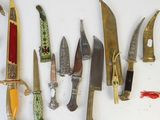 several different types of knives are lined up on a white surface