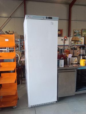 an image of a refrigerator in a warehouse with other appliances