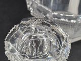 a glass vase with a flower inside of it on a table