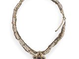 a close up of a necklace on a white background