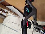 a close up of a bicycle with a clock on the handlebars