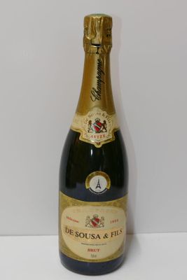 the bottle of champagne is sitting on the table next to the wall