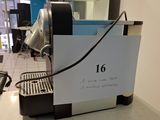 a coffee machine with a sign on it sitting on a counter