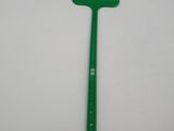 a green plastic spatula on a white surface
