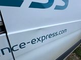 a white van with a blue logo on the side of it