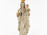 a statue of a woman holding a child wearing a crown