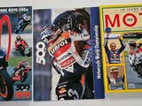 three books on the wall of a motorcyclist ' s garage