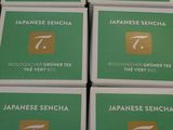 six boxes of japanese sencha on display in a store