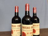 three bottles of wine sitting on top of a table next to each other