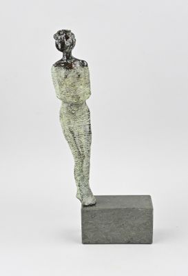 an image of a sculpture of a woman standing on a block
