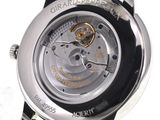 a close up of a watch on a white surface