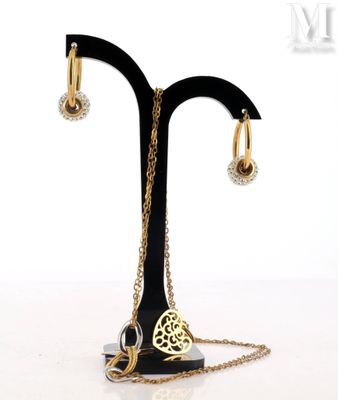 a necklace and earrings on a stand with a chain